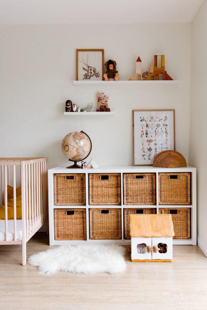 Property management tips. A child's bedroom with neutral aesthetic. There is a crib, storage cabinet and a fluffy rug.